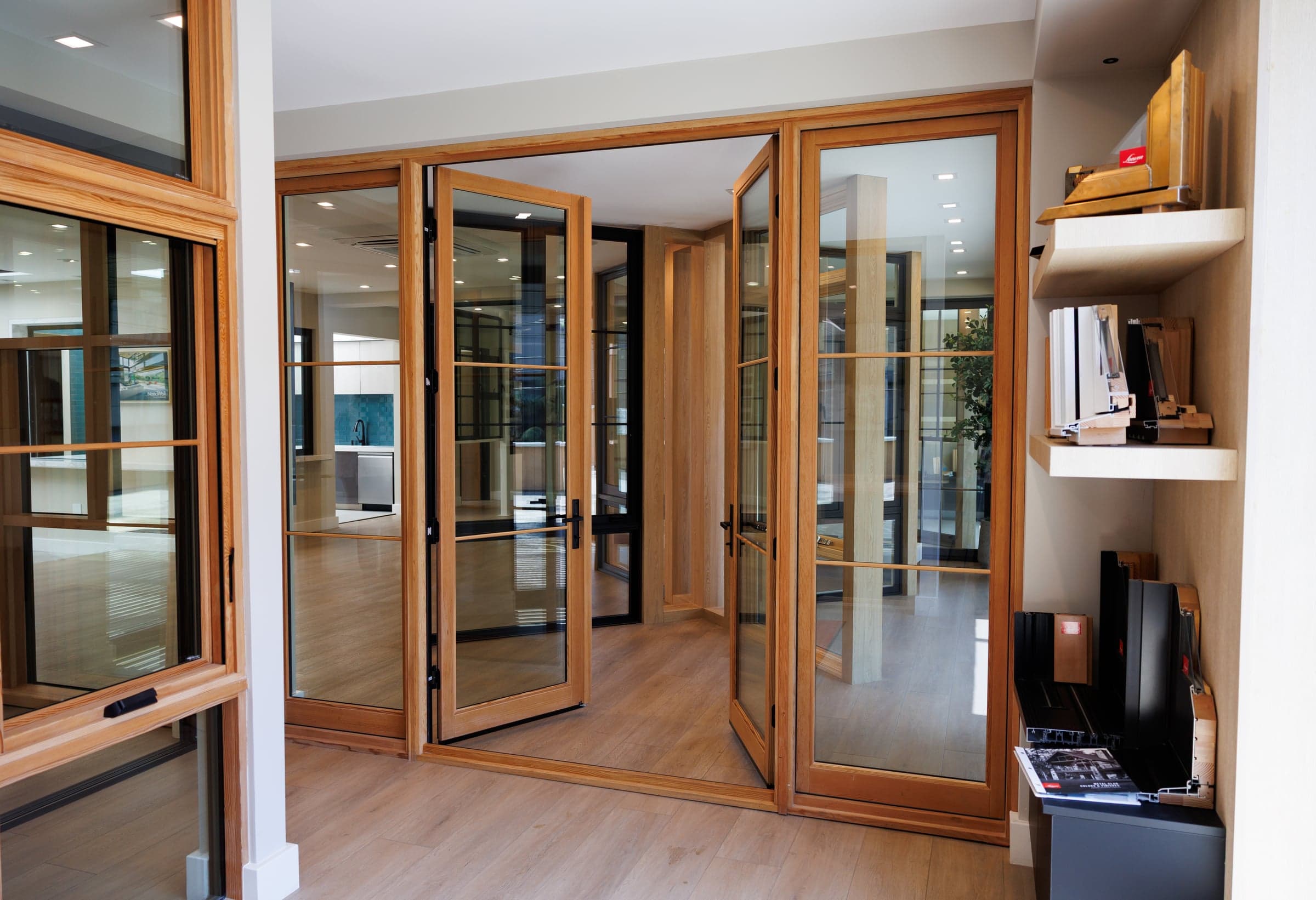 Loewen warm wood folding door system open to the showroom floor — interior view